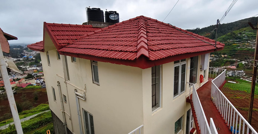 red roof cottage with side balcony overlooking hillside and town view