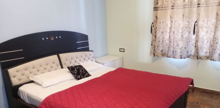 bedroom with large bed and window curtains