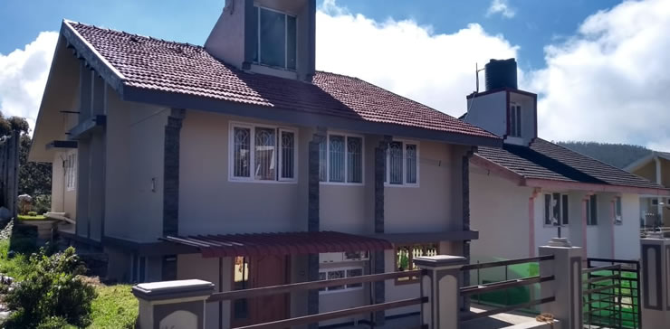 front view of ooty cottage with red tiled roof