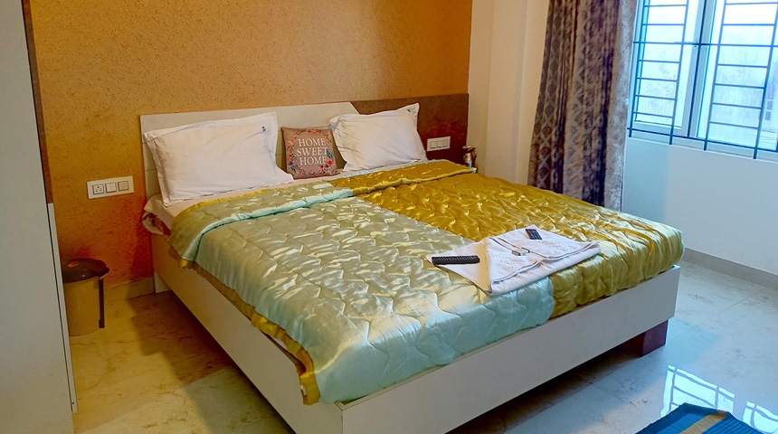 RJ cottage bedroom with a double bed and golden bedding
