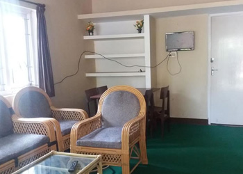 ARN Cottage living room interior with wicker chairs and dining table
