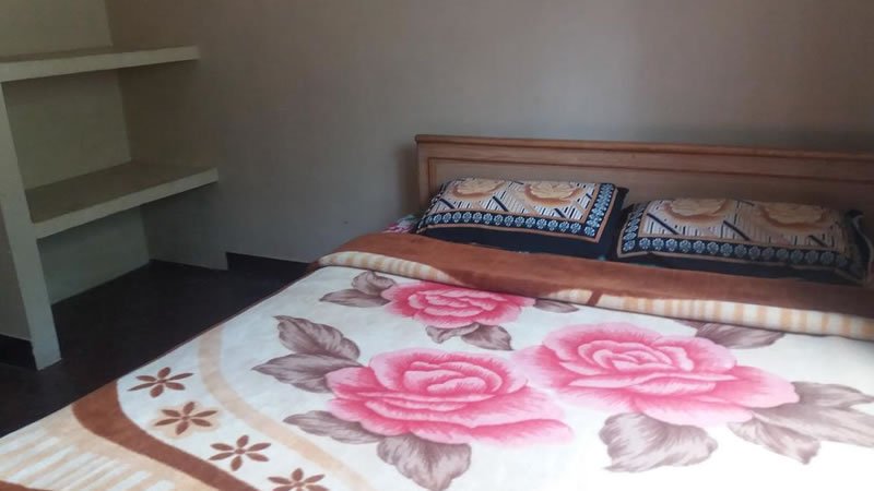 Double bedroom with floral blanket