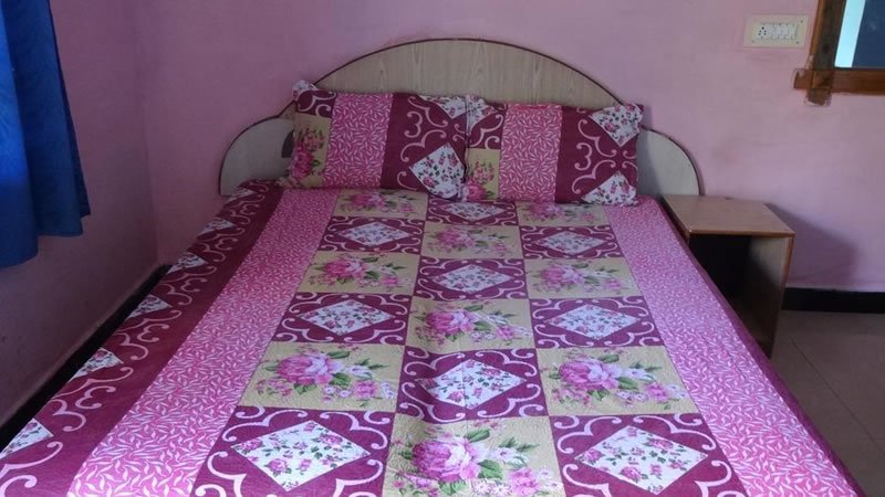 Double bed with floral bedsheet