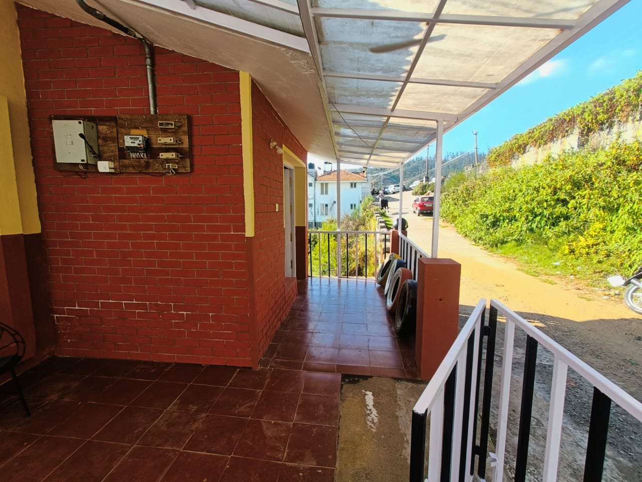 Cottage outdoor corridor leading to rooms and entrance