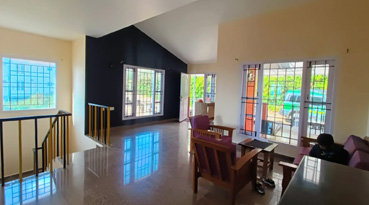 Spacious cottage living room with large windows
