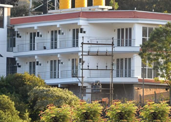 Divi Heritage Inn showcasing modern rooms with balconies and scenic hill views