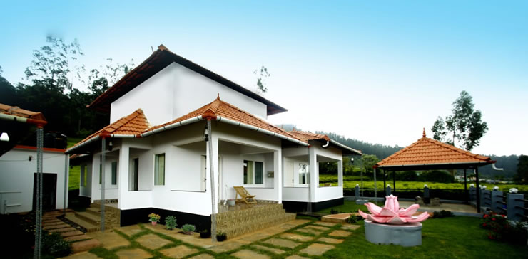 Front view of Ooty estate cottage with tiled roof, garden walkway, and outdoor seating area