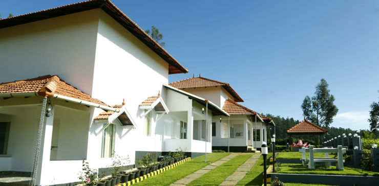 Side angle of estate cottage in Ooty on a bright sunny day with landscaped garden and pathway