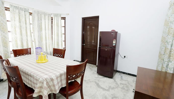 Dining area with a fridge at GM Family Cottage