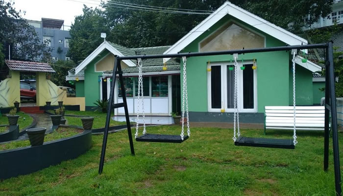 Exterior view of Green Garden Cottage with a playing area