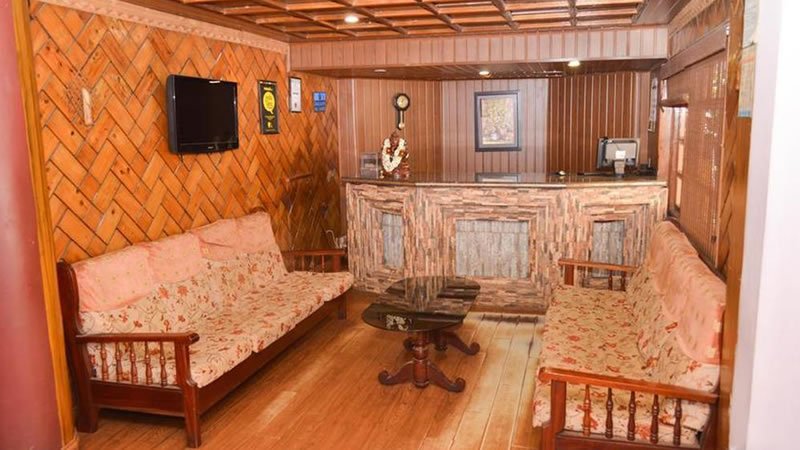 Reception and lounge area with wooden interiors, sofas and front desk