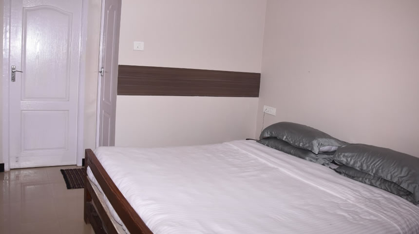 Minimal double bedroom with wooden bed and modern interior