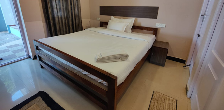 Clean and comfortable bedroom at HVN Cottage with double bed and modern interiors