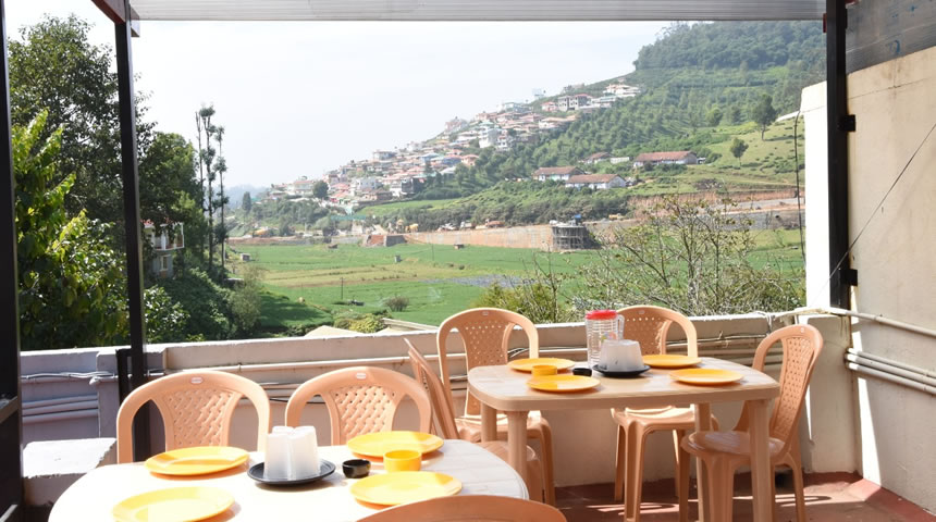 Terrace dining area with scenic hill and valley view
