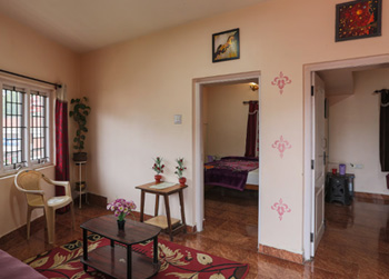 KGP Cottage living hall interior with seating area and bedroom entrance