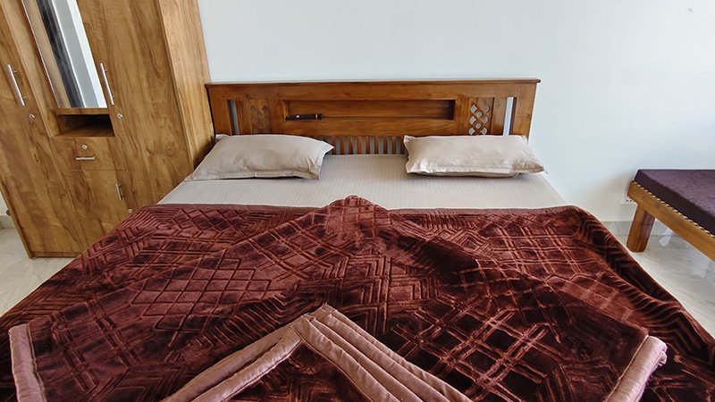 Bedroom with wooden bed and wardrobe