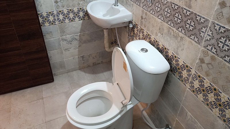 Bathroom with toilet and wall-mounted sink