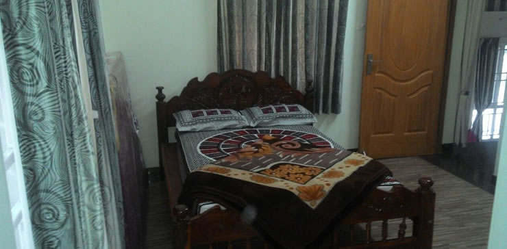 Cozy bedroom with wooden bed and warm interiors at Toy Cottage