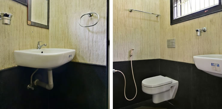 Clean, modern attached bathroom with wash basin, wall-mounted toilet, and contemporary fittings at Toy Cottage