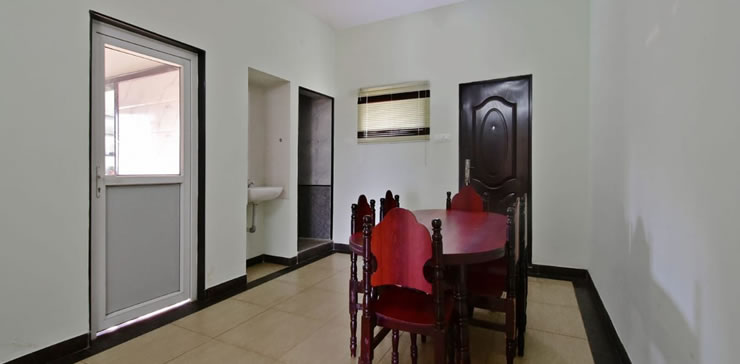 Dining area with wooden table and chairs at Toy Cottage