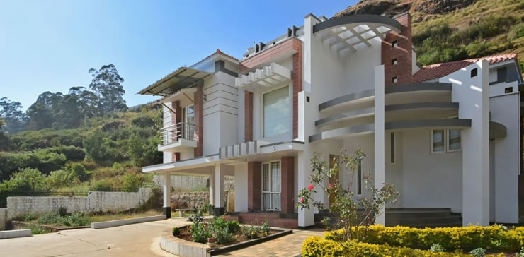 Spacious modern villa exterior with landscaped garden at Toy Cottage