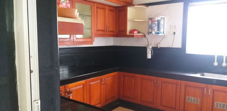 Fully equipped modular kitchen with wooden cabinets at Toy Cottage